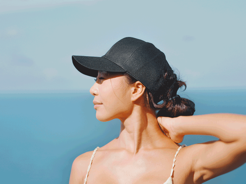 An image showing a lady relaxed at a beach.